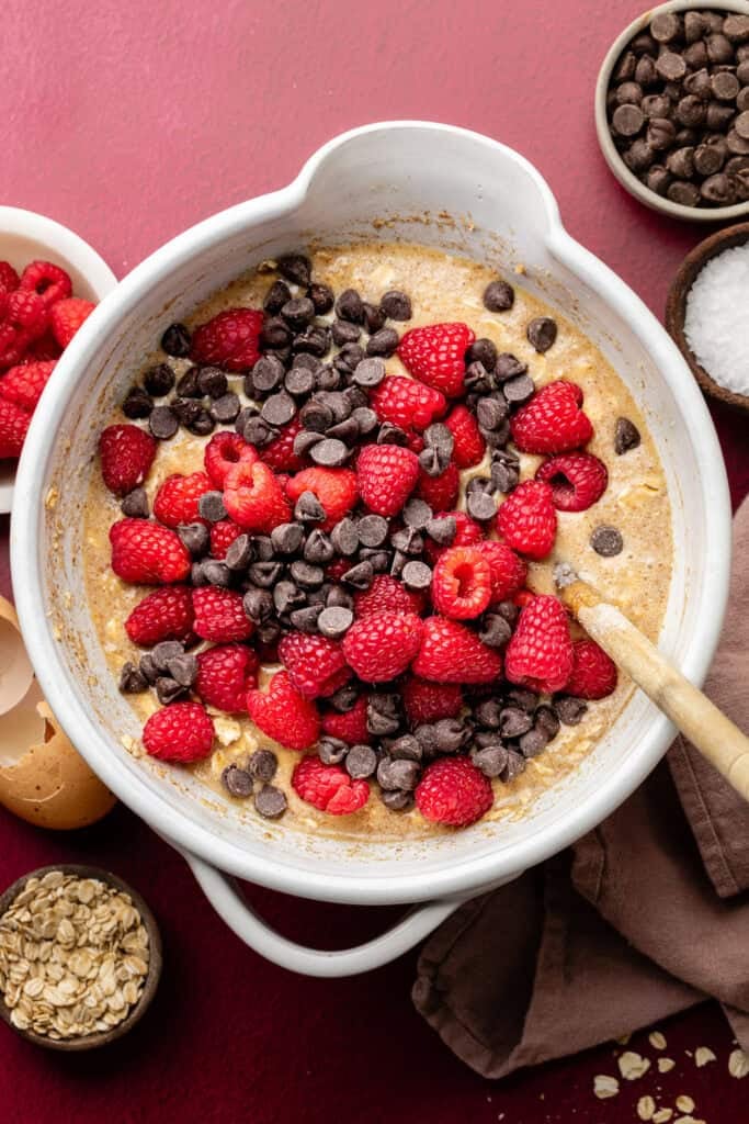 baked oatmeal batter with raspberries and chocolate chips