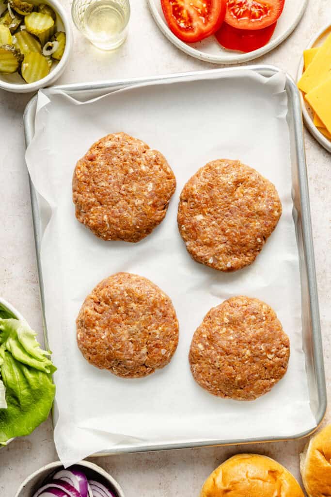 turkey burger patties on sheet pan lined with parchment paper