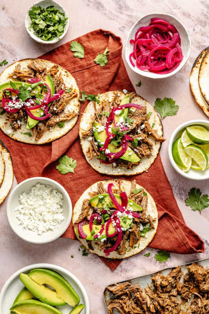 slow cooker shredded beef tacos with toppings