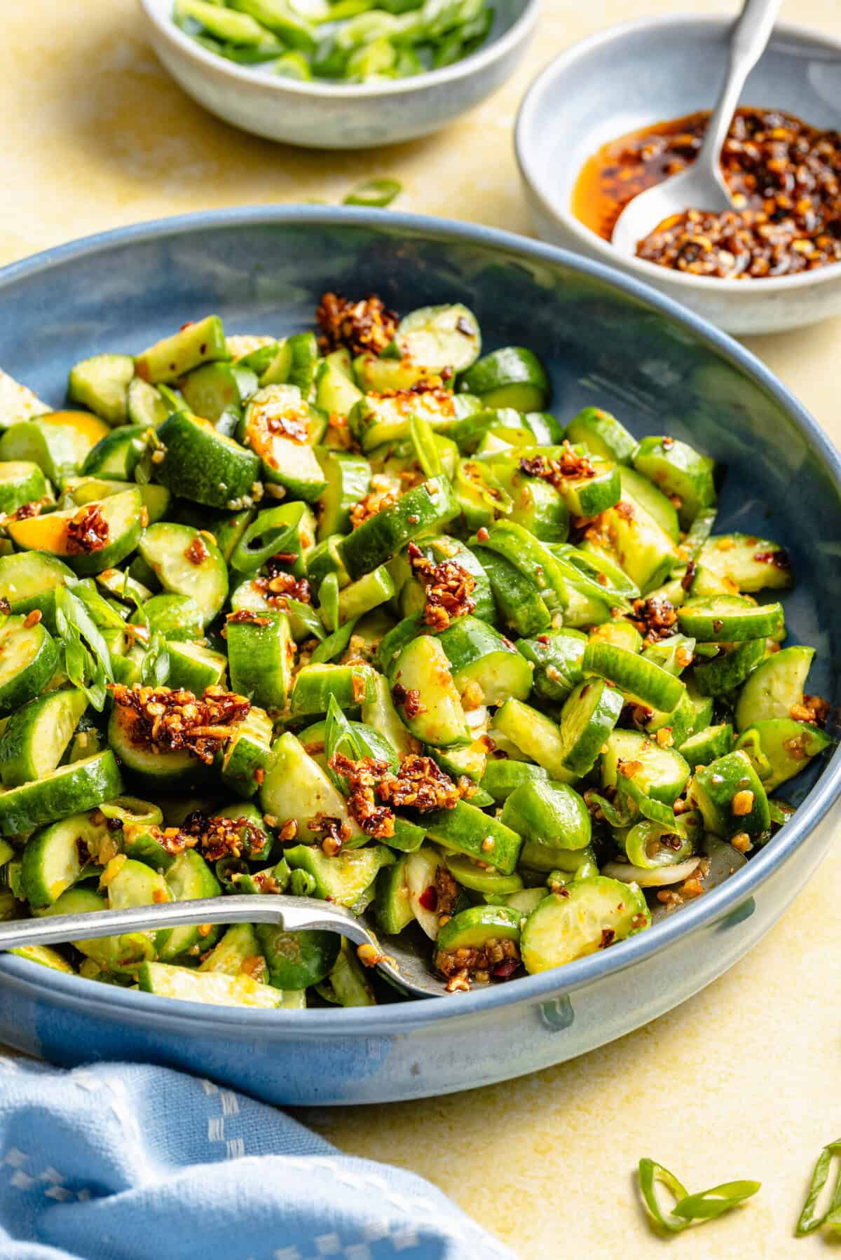 cucumber salad in bowl with spoon