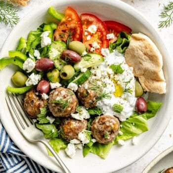 greek meatballs in bowl with veggies and tzatziki