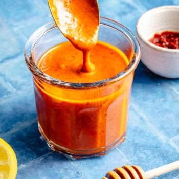 harissa dressing in mason jar with spoon