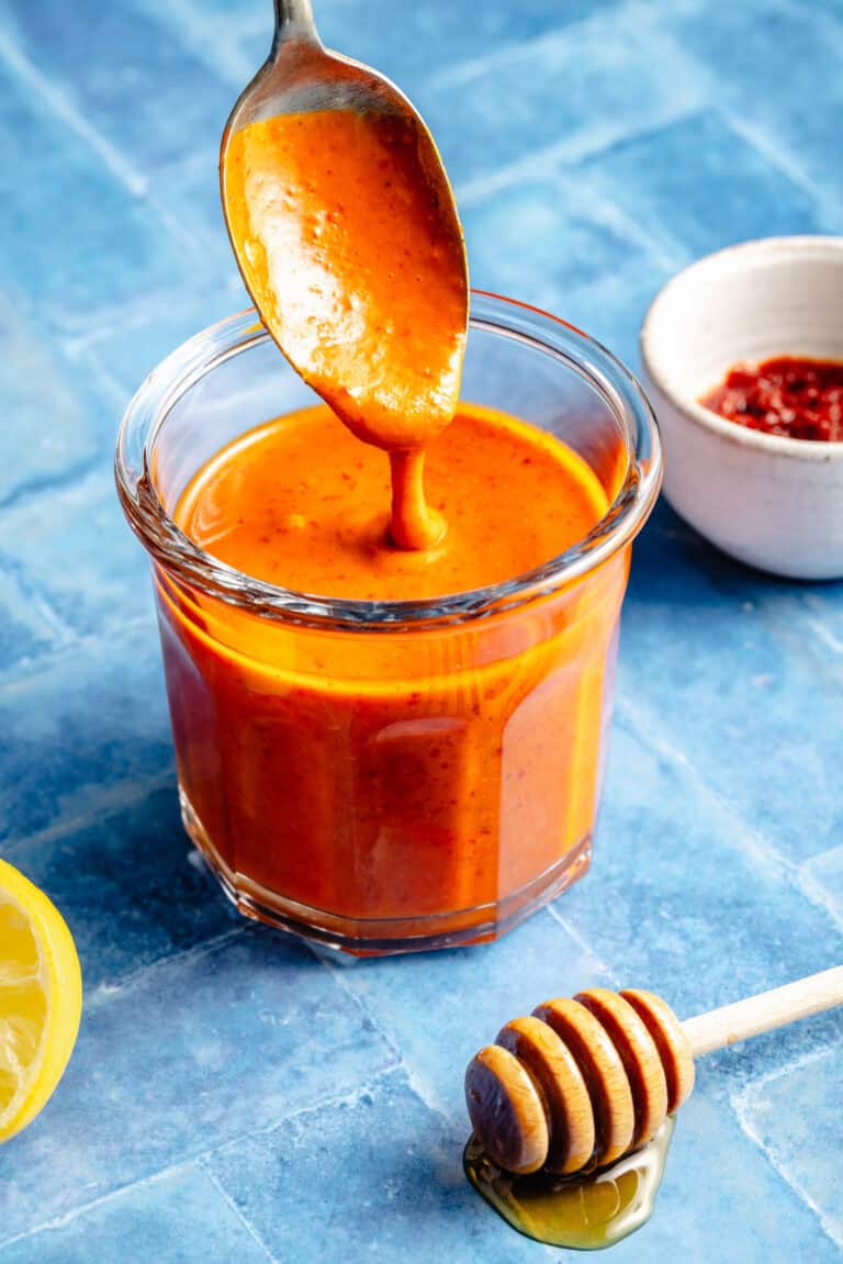 harissa dressing in mason jar with spoon