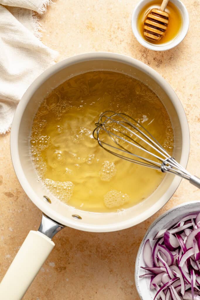 vinegar and honey in pot with whisk
