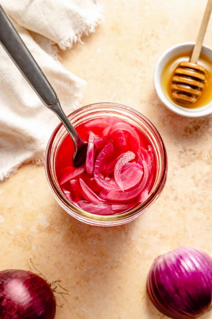 pickled onions in jar with fork