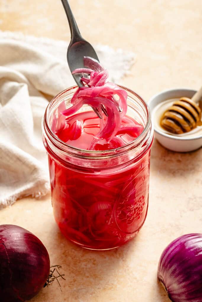 pickled onions in jar with fork