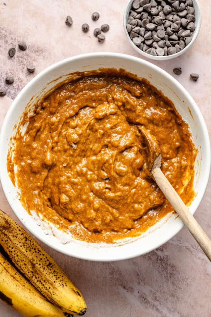 pumpkin banana bread batter in bowl with spoon