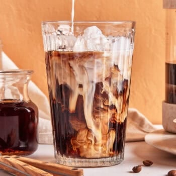 milk being poured iced coffee