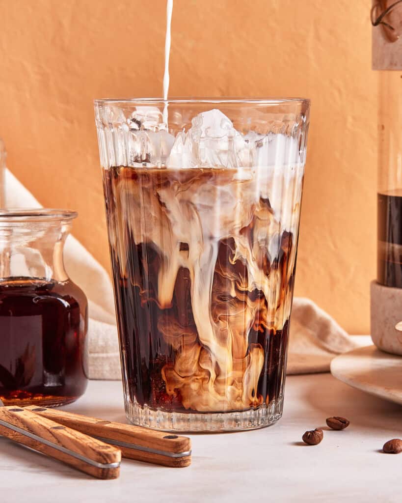 milk being poured iced coffee