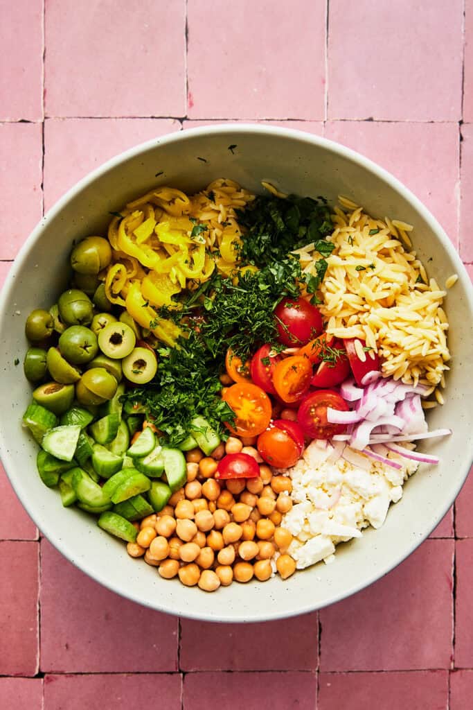 pasta salad ingredients in mixing bowl