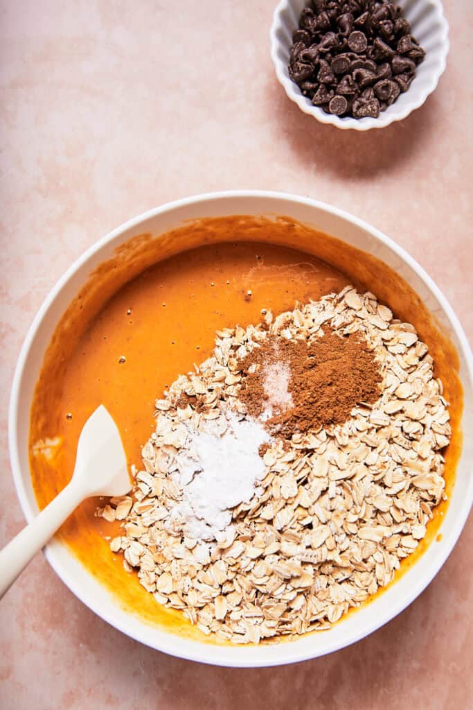 dry ingredients being added to wet ingredients with spatula