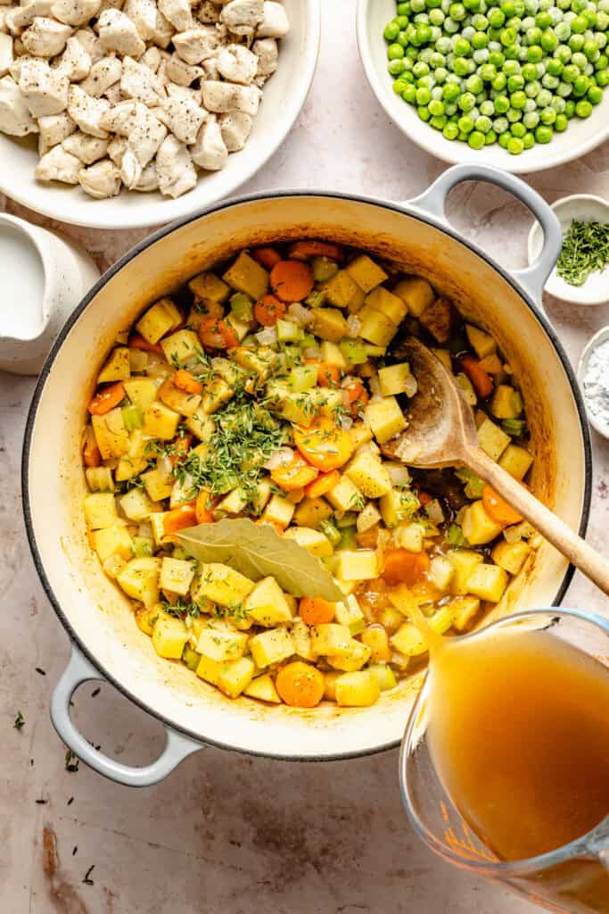 veggies, bay leaf, and herbs in dutch oven