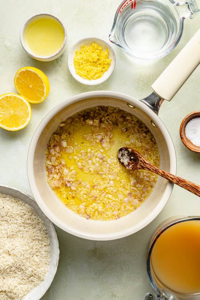 rice in pot with wooden spoon
