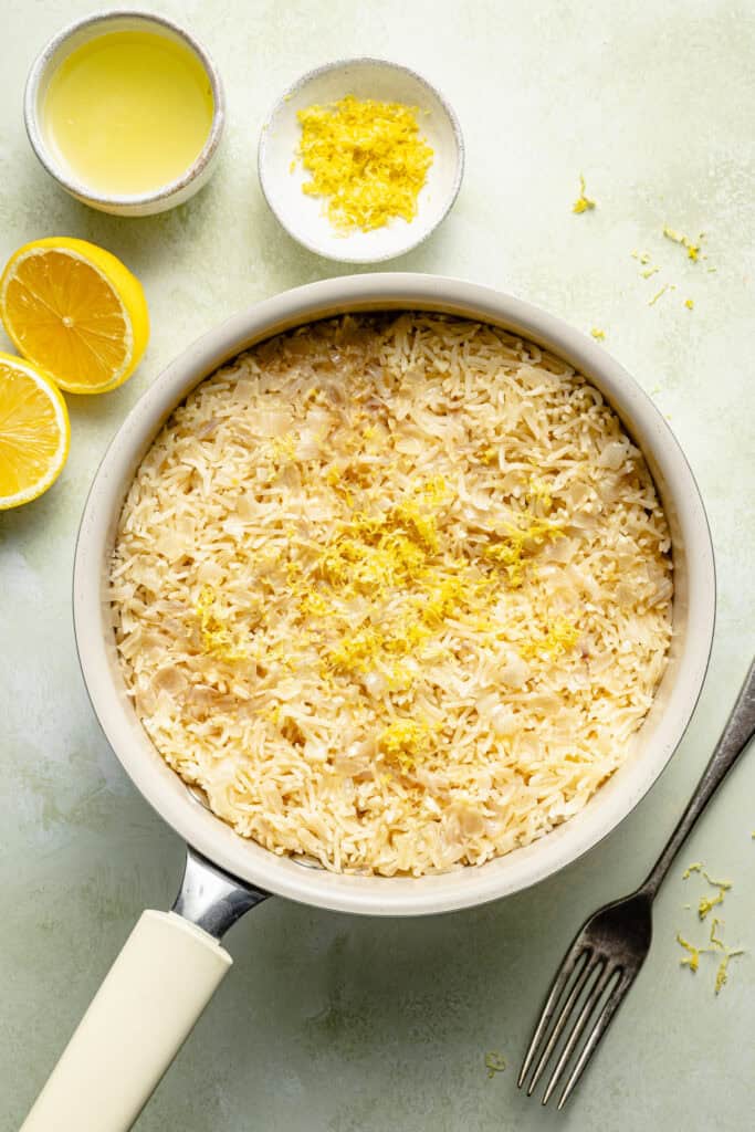 lemon rice in pot with lemon zest