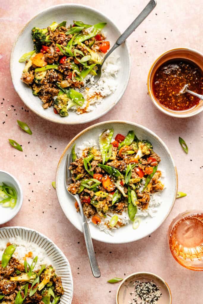 teriyaki beef stir fry over rice in bowl