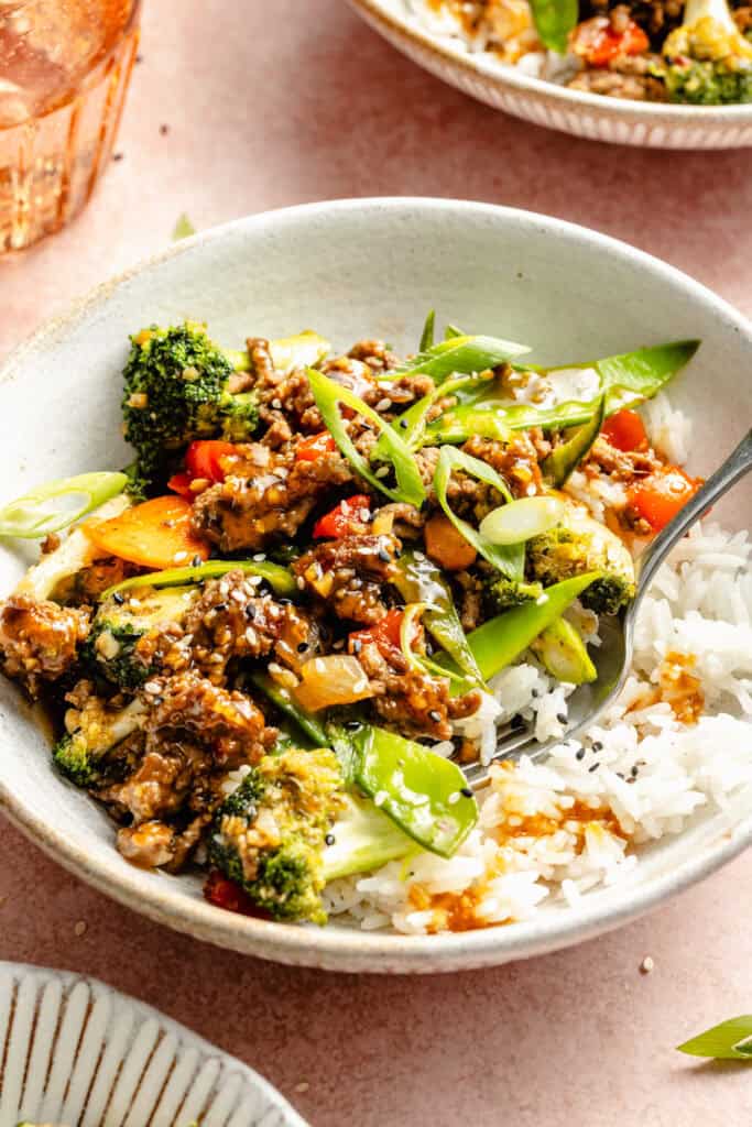 teriyaki beef stir fry over rice in bowl
