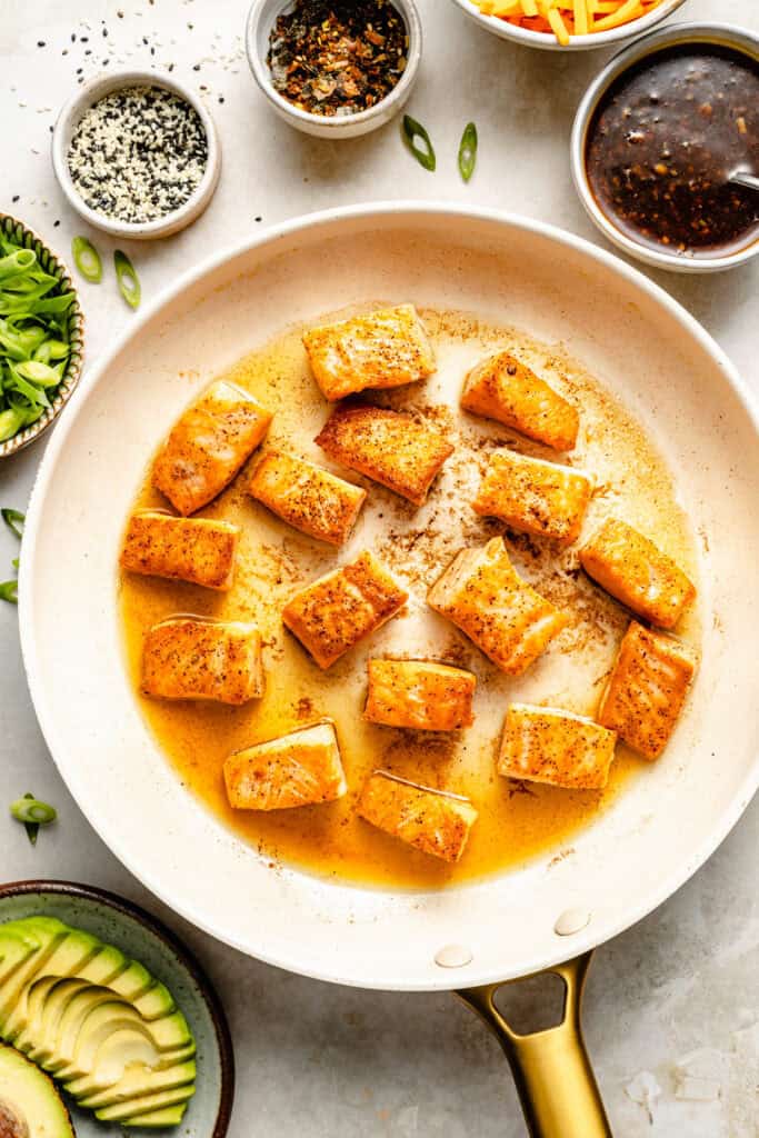 salmon being seared in pan