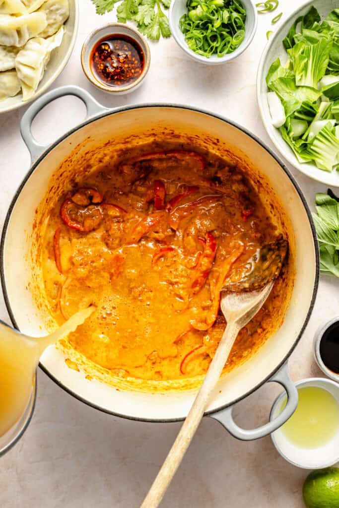 broth being poured into pot