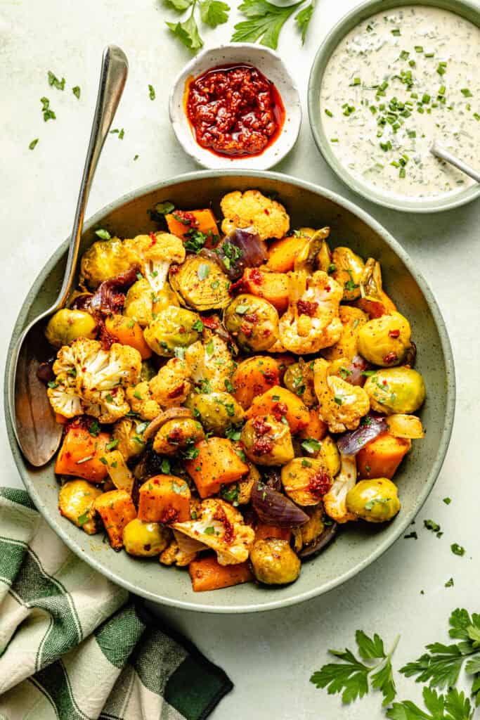 harissa roasted vegetables in serving dish with spoon
