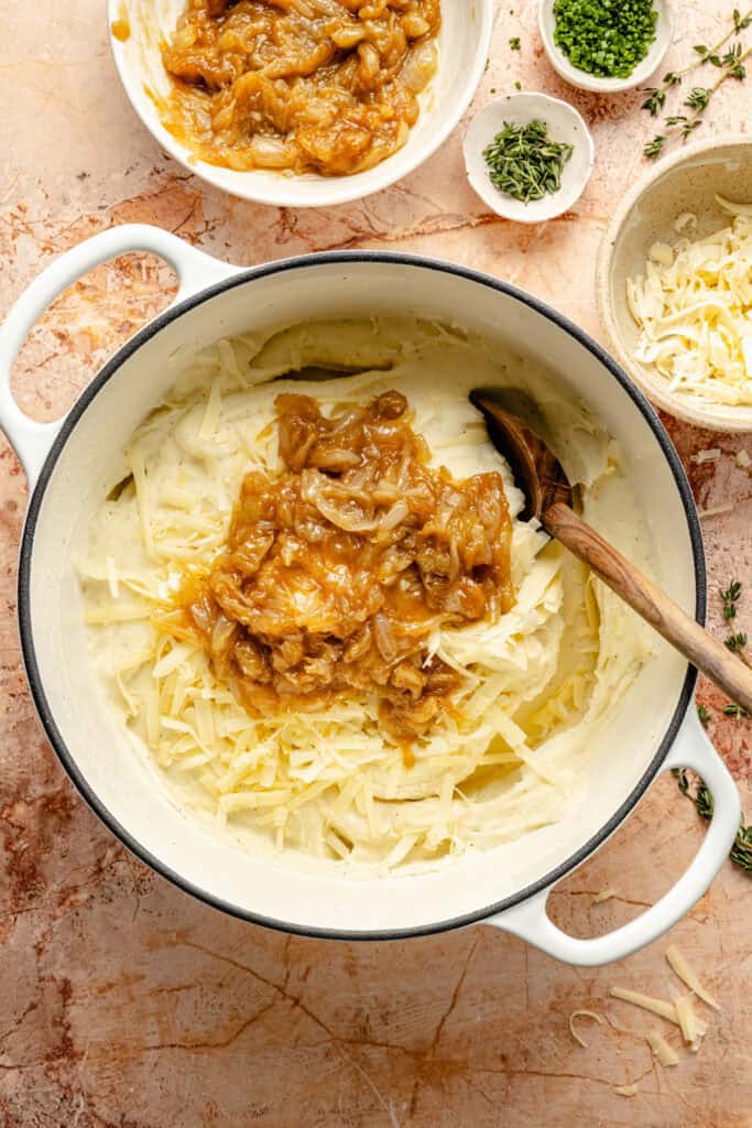 caramelized onions being stirred into mashed potatoes
