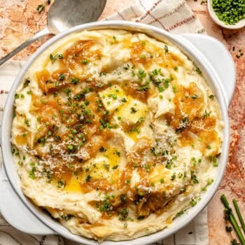 caramelized onion mashed potatoes in serving dish topped with butter