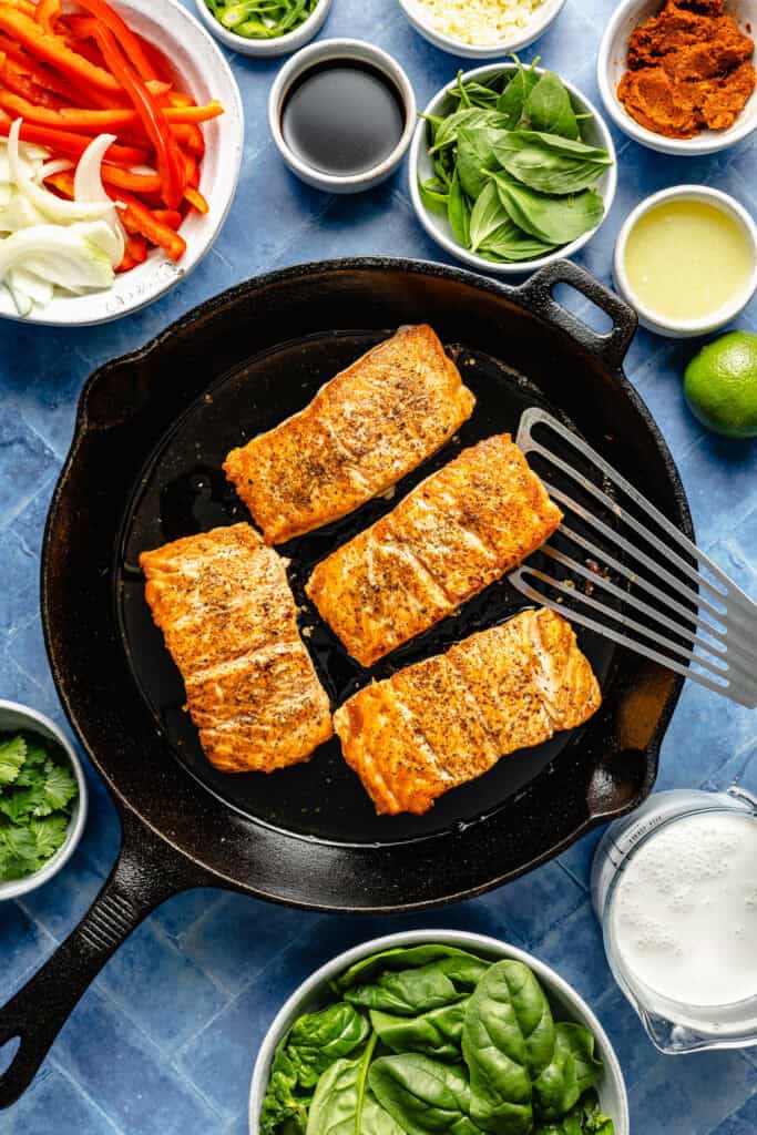 salmon being seared in pan