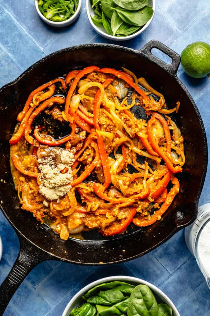 veggies and curry paste in skillet