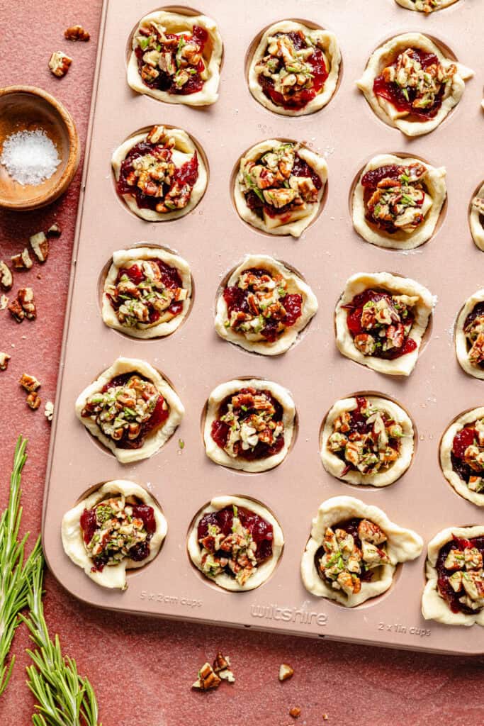 brie bites in muffin tin before baking