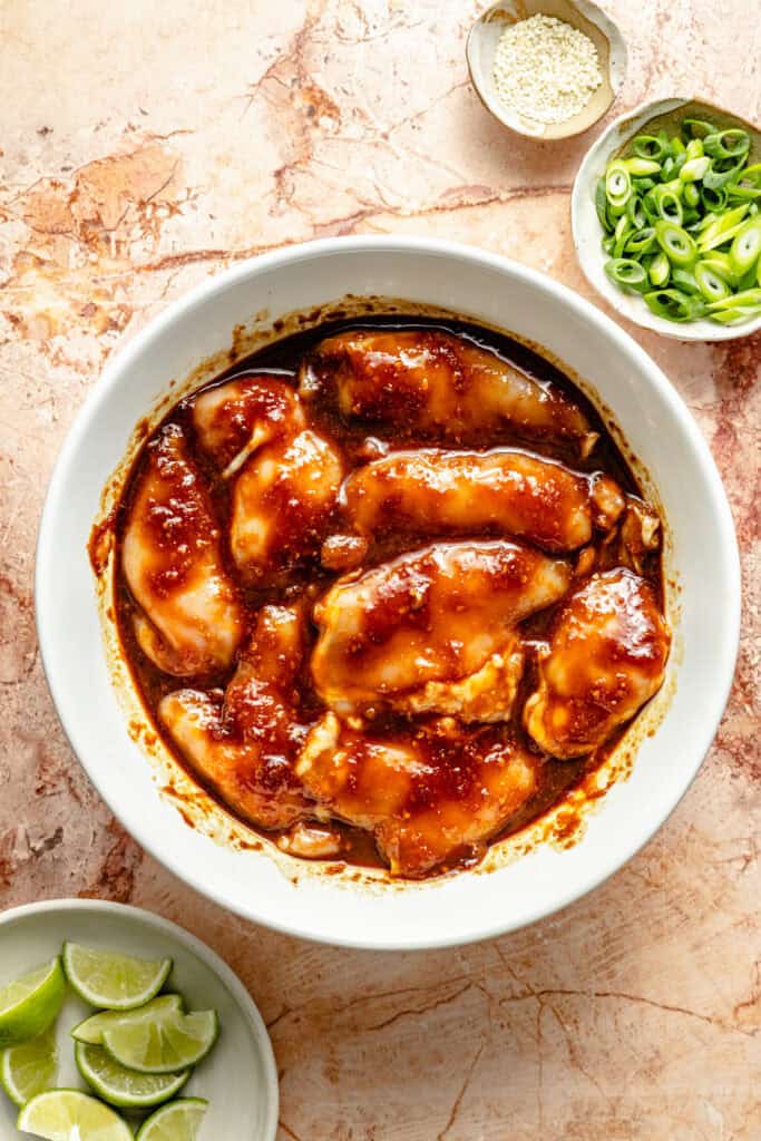 chicken thighs in bowl with miso glaze