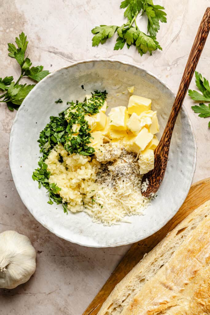 herbs, butter, garlic, and cheese in bowl