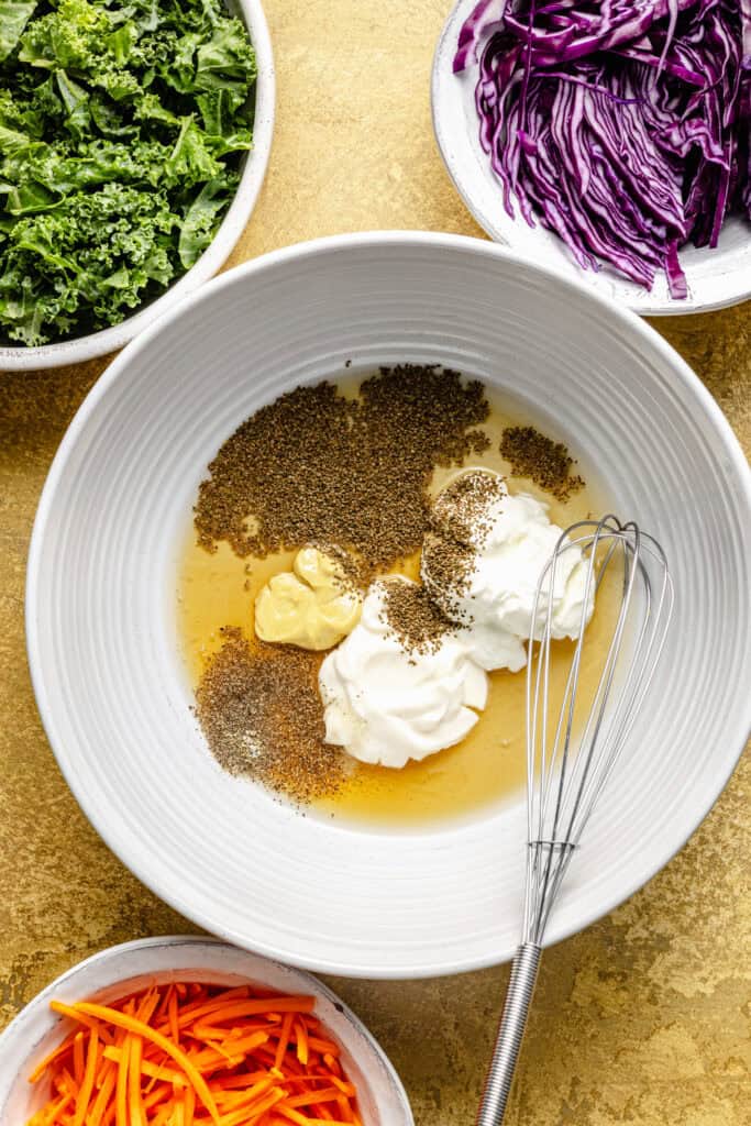 slaw dressing ingredients in mixing bowl with whisk