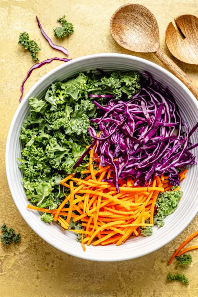 kale, cabbage, and carrots in mixing bowl
