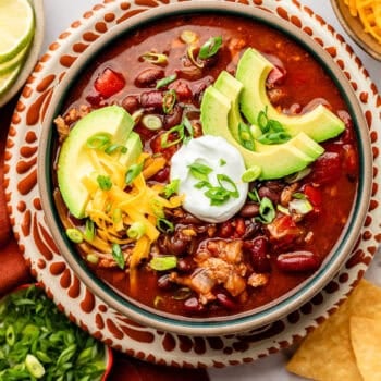 slow cooker turkey chili in bowl with toppings