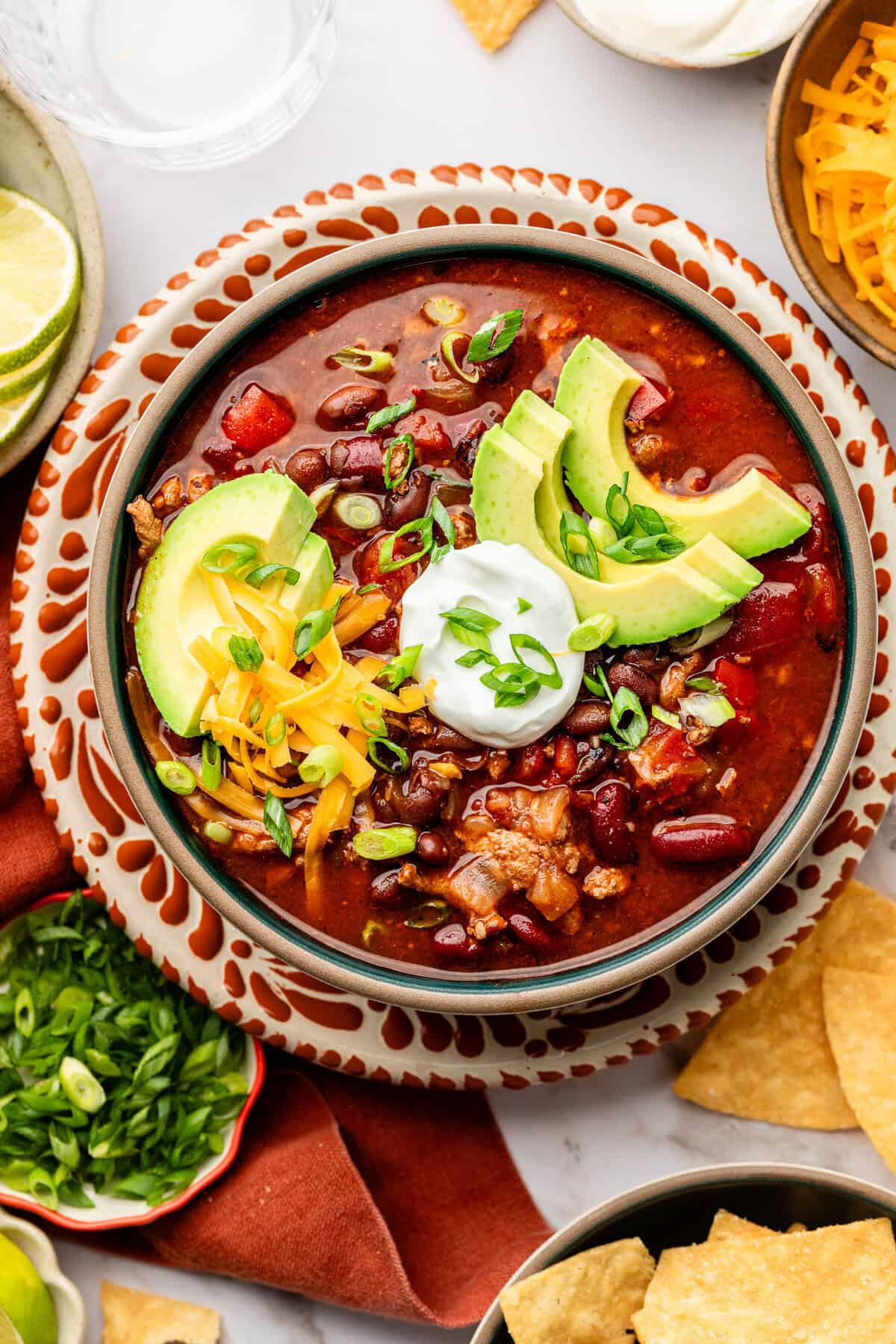 slow cooker turkey chili in bowl with toppings