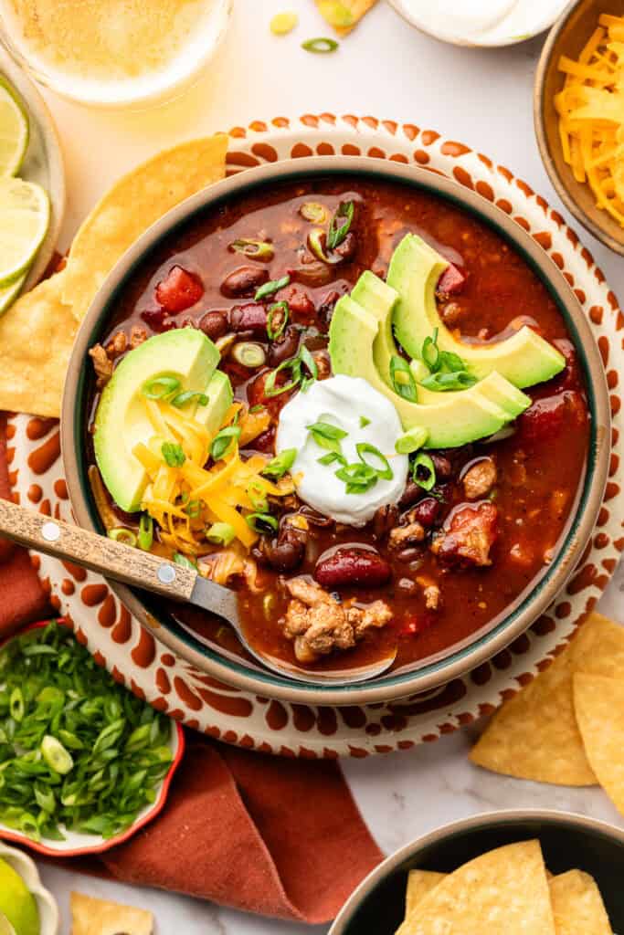 slow cooker turkey chili in bowl with toppings