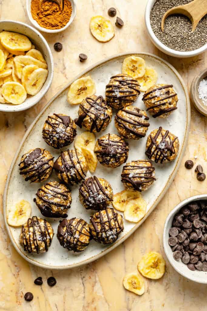 energy bites on plate drizzled with chocolate