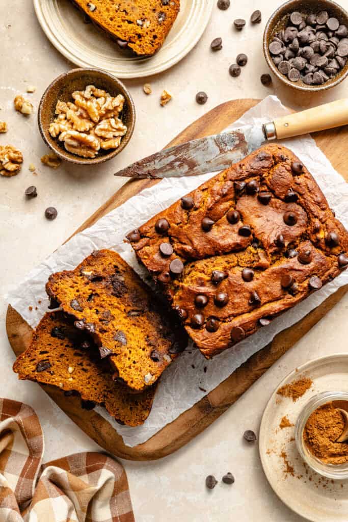 pumpkin bread sliced on sheet of parchment