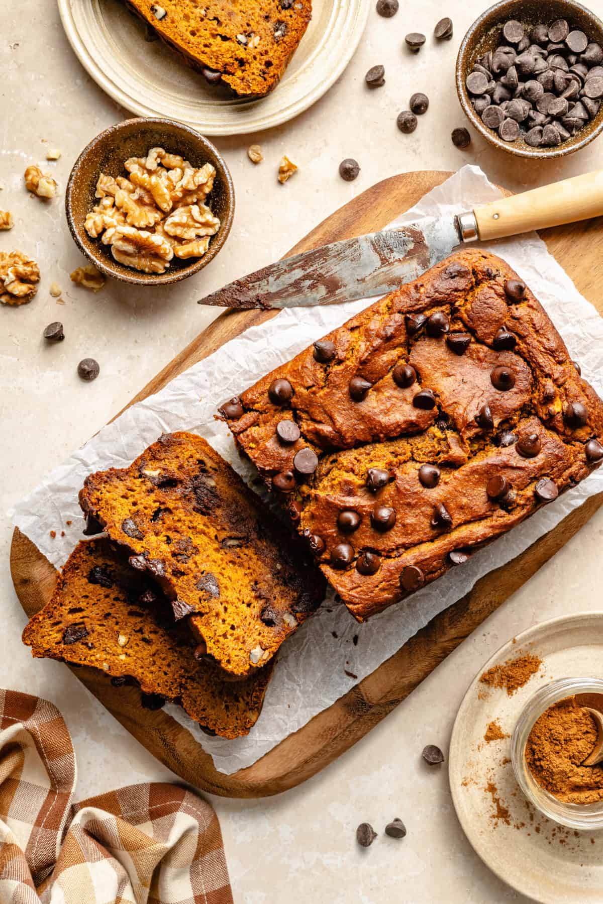 pumpkin bread sliced on sheet of parchment