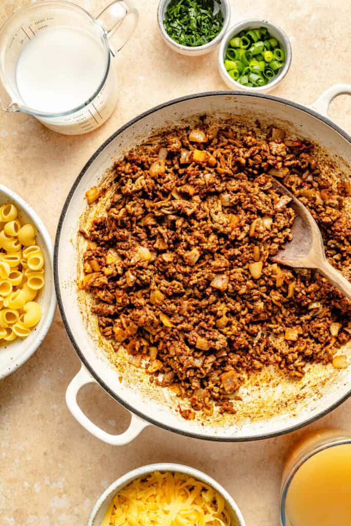 hamburger and onion being cooked in skillet