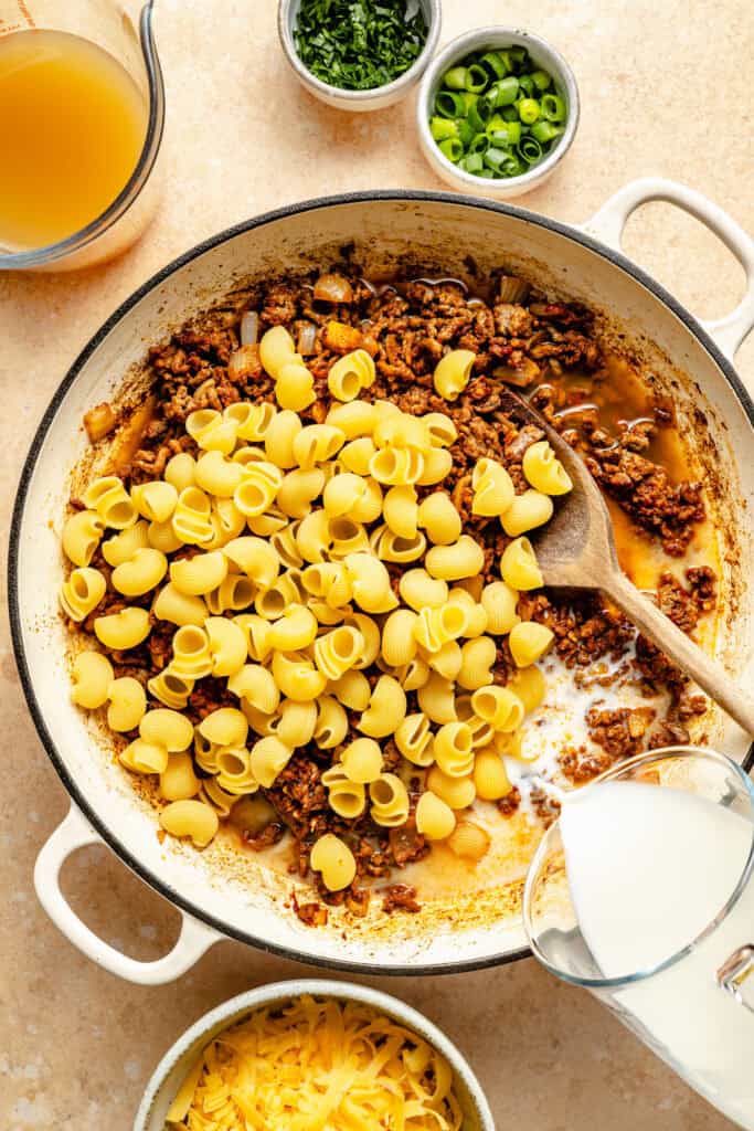 milk being added to skillet 