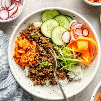 korean inspired beef bowl with toppings and fork