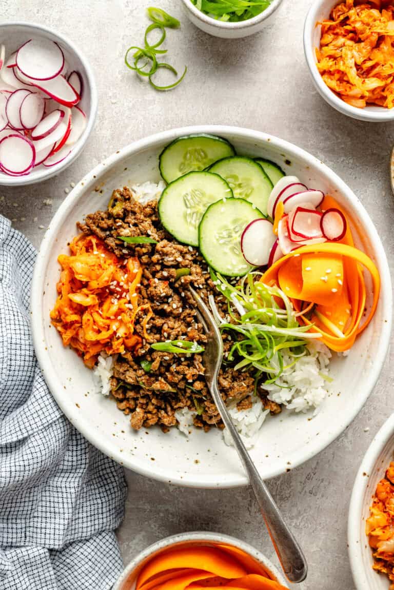 korean inspired beef bowl with toppings and fork