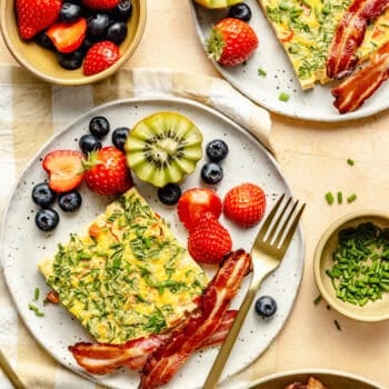 sheet pan eggs on plate with bacon and fruit