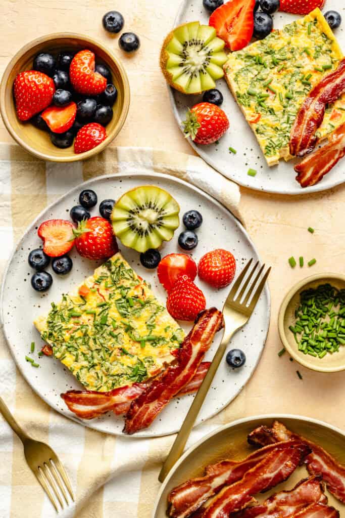 sheet pan eggs on plate with bacon and fruit