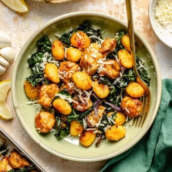 sheet pan gnocchi in bowl with a fork