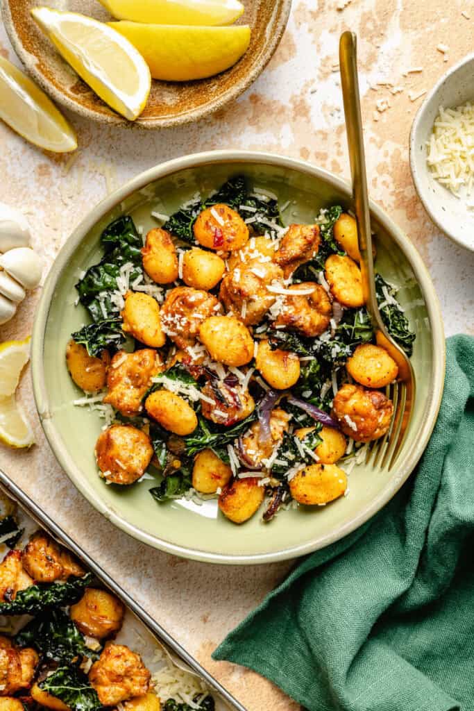 sheet pan gnocchi in bowl with a fork