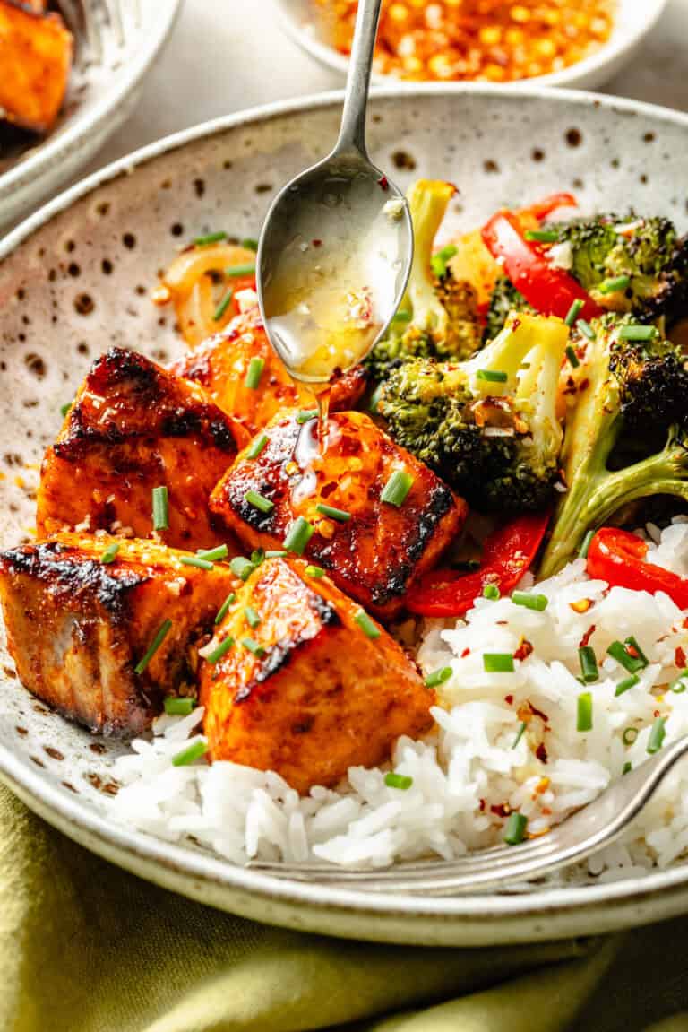 salmon and veggies in bowl over rice