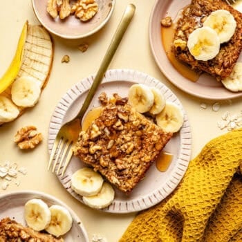 baked oatmeal on a plate with sliced bananas and fork