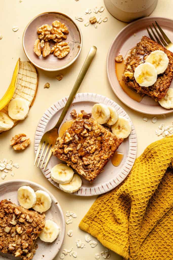 baked oatmeal on a plate with sliced bananas and fork