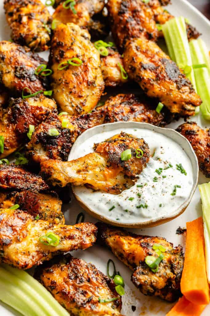 buffalo ranch wing being dipped in dressing